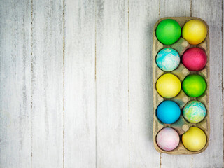 Multicolored painted eggs on a gray background. Easter concept