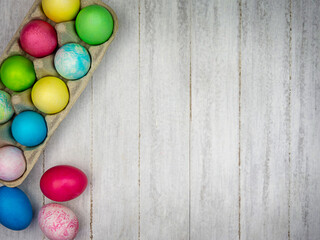 Multicolored painted eggs on a gray background. Easter concept