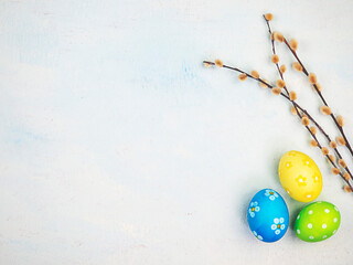 Multicolored painted eggs on a blue background. The concept of Easter. Place for text