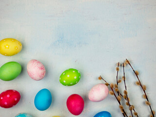 Fototapeta na wymiar Multicolored painted eggs on a blue background. The concept of Easter. Place for text