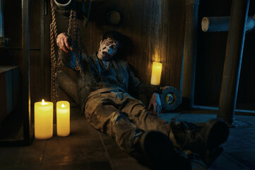 Fototapeta na wymiar Chained zombie in basement of abandoned house