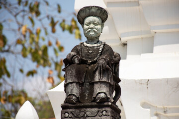 Ancient architecture antique chinese ballast doll stone statue at Wat Pho Bang O temple for thai...