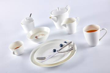 Breakfast milk cereal with blueberries in white cutlery