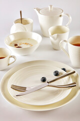 Breakfast milk cereal with blueberries in white cutlery