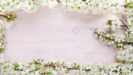 Naklejka na ściany i meble Plum flowers on a wooden background