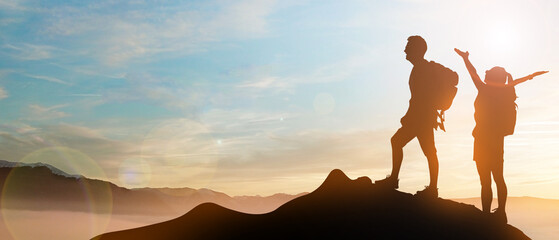 Peace, freedom adventure concepts with silhouettes Climbing Couples on mountainous cliffs. Success...