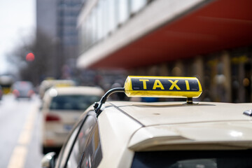 Taxi sign on a car in a busy street at day time in Berlin