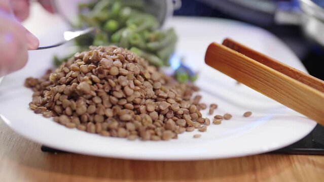Cooked lens and string beans vegetable on plate serving 4K