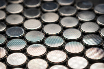 CR2032 coin cell batteries background closeup pan slide