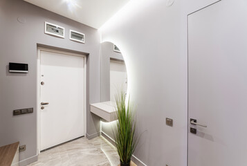 bright interior of the corridor with white doors and mirror