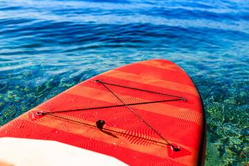 red supboard on peace and quiet water sea outdoors sunny day