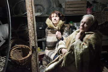 Frightened women hide from explosions in the basement. During the sirens due to the shelling of Kyiv. Ukraine