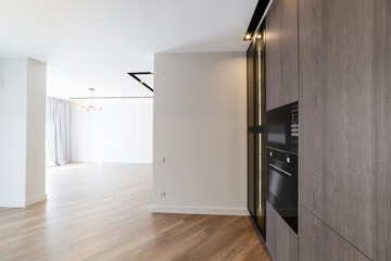white interior in the house with dark furniture in the kitchen