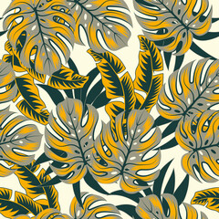 Original seamless tropical pattern with bright plants and leaves on a beige background. Tropic leaves in bright colors. Trendy summer Hawaii print. Colorful stylish floral.