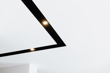 white ceiling with black track lamp