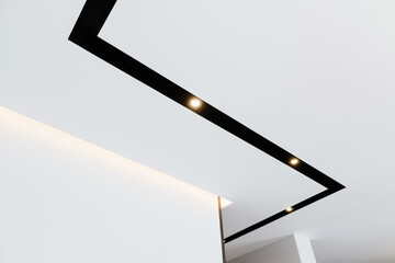 white ceiling with black track lamp and lighting