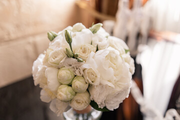 wedding bouquet of white roses in the room in the morning