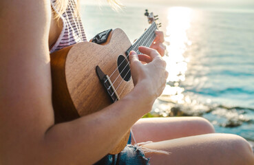 Summer Vacation, caucasian women relaxing and playing on ukulele on beach, so happy and luxury in...
