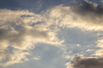 Fototapeta premium beautiful spring sky, covered with big clouds. extremely amazing, dramatic and apocalyptic sky and the sun and sunny rays. the sun is shining through dark clouds. sunshine. sunset