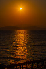 Gold time of the day on a beach in Turkey, near Kusadasi with hills in horizon