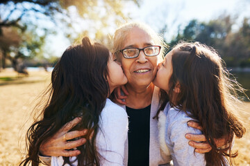 Its a blessing to have grandchildren. Cropped shot of a grandmother getting kissed on the cheeks by her two adorable granddaughters. - obrazy, fototapety, plakaty