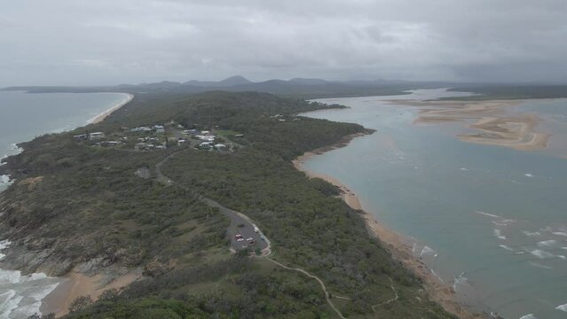 Cars On Sir Raphael Cilento Drive Near FV Dianne Memorial In Wave Lookout In Town Of 1770, QLD, Australia. aerial drone pullback
