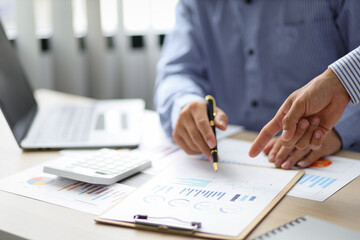 Fototapeta premium Businessman consulting analyzing income charts and graphs with financial report. Strategy analysis and business planning concept.