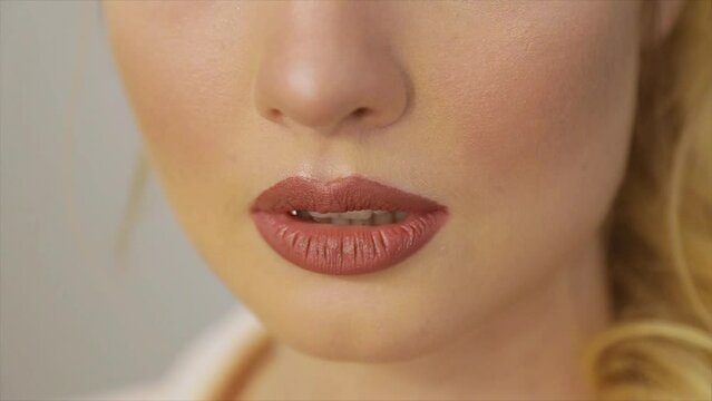 Woman's lips painted with red lipstick