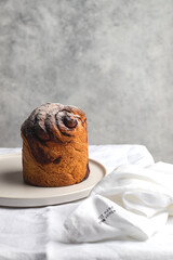 Traditional Easter cake served on white plate on white linen tablecloth
