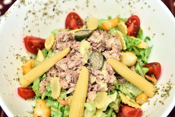 A salad is a dish consisting of mixed, mostly natural ingredients with at least one raw ingredient. 