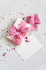 Top view of beautifully wrapped gift box decorated with pink silk ribbon.