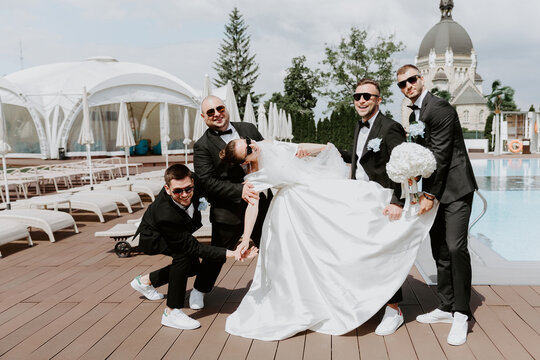 Positive bride and groomsman in sunglasses . Best friends on wedding.