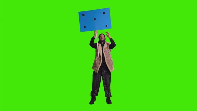  A serious guy is protesting and shouting loud with a playcard in his hands on greenscreens
