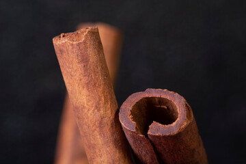 macro shot of cinnamon sticks on black background