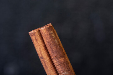 macro shot of cinnamon sticks on black background