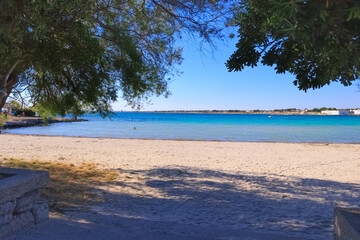 Puglia beach: the beautiful sandy bay of Sant’Isidoro, inside  the Marine Protected  Area of...