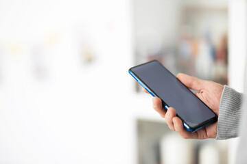 Male hands typing on smartphone