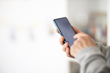 Male hands typing on smartphone