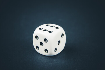 White dice on black table background