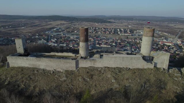 A tracking aerial drone shot of the Chęciny Royal Castle while moving upward towards the right. This is located in Poland. It fell into ruin in the 18th century and remains in that state to this day.