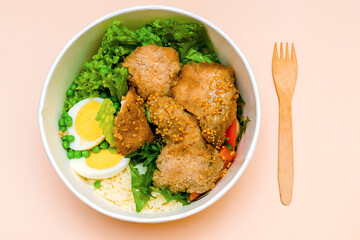 Healthy food lunch in kraft paper carton eco friendly box disposable bowl packaging container on pink background. chicken, rice, eggs, greens. Take away delivery. environment protection. top view