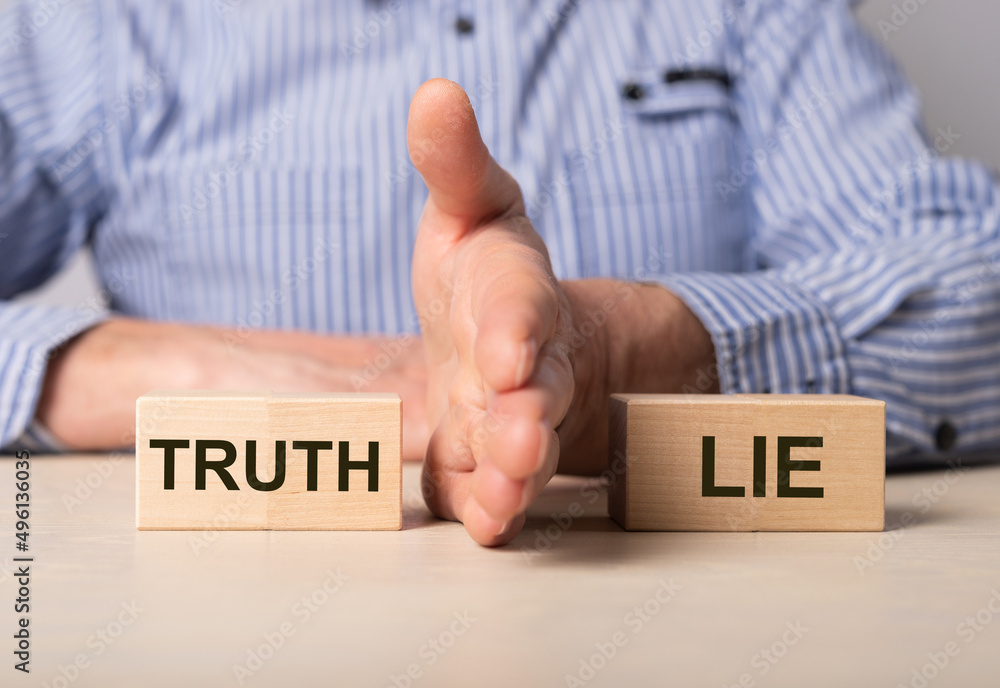 Poster man divides blocks with words truth and lie. confrontation between true and false information, news,