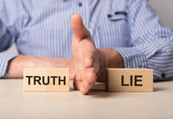 Man divides blocks with words truth and lie. Confrontation between true and false information, news, actions. Choice between deception and honesty. High quality photo - obrazy, fototapety, plakaty