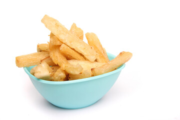 Fried cassava in a blue bowl on a white background, copy space, texture, Indonesian food.