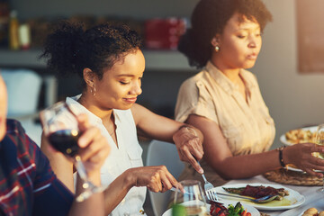 Shes the top carnivore in the group. Shot of a group of friends enjoying a meal and drinks together around a table at a gathering outdoors.