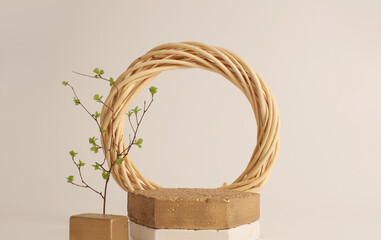 Gold stones platform podium, wood ring and leaf twig on beige copy space background. Minimal...