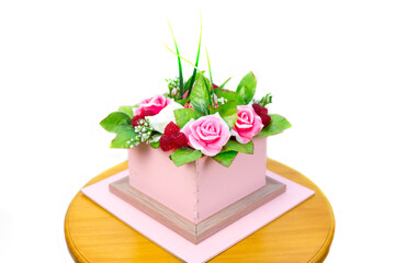 Obraz premium Composition of flowers and berries cardboard box isolated white background.