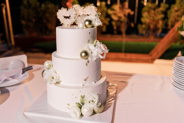 big beautiful wedding cake near the arch in the evening