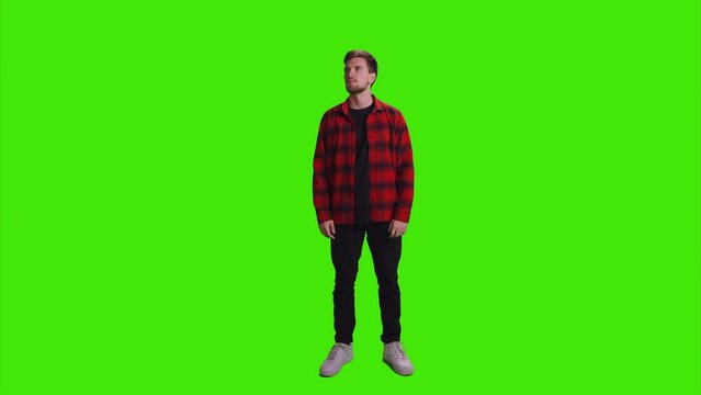 A gentleman is standingh alone and starring everything on greenscreen
