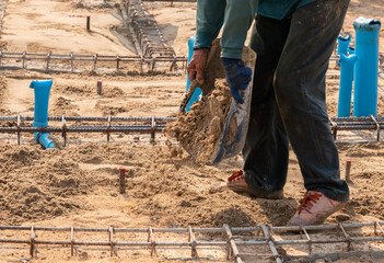 Workers fill san to ground for adjust level.